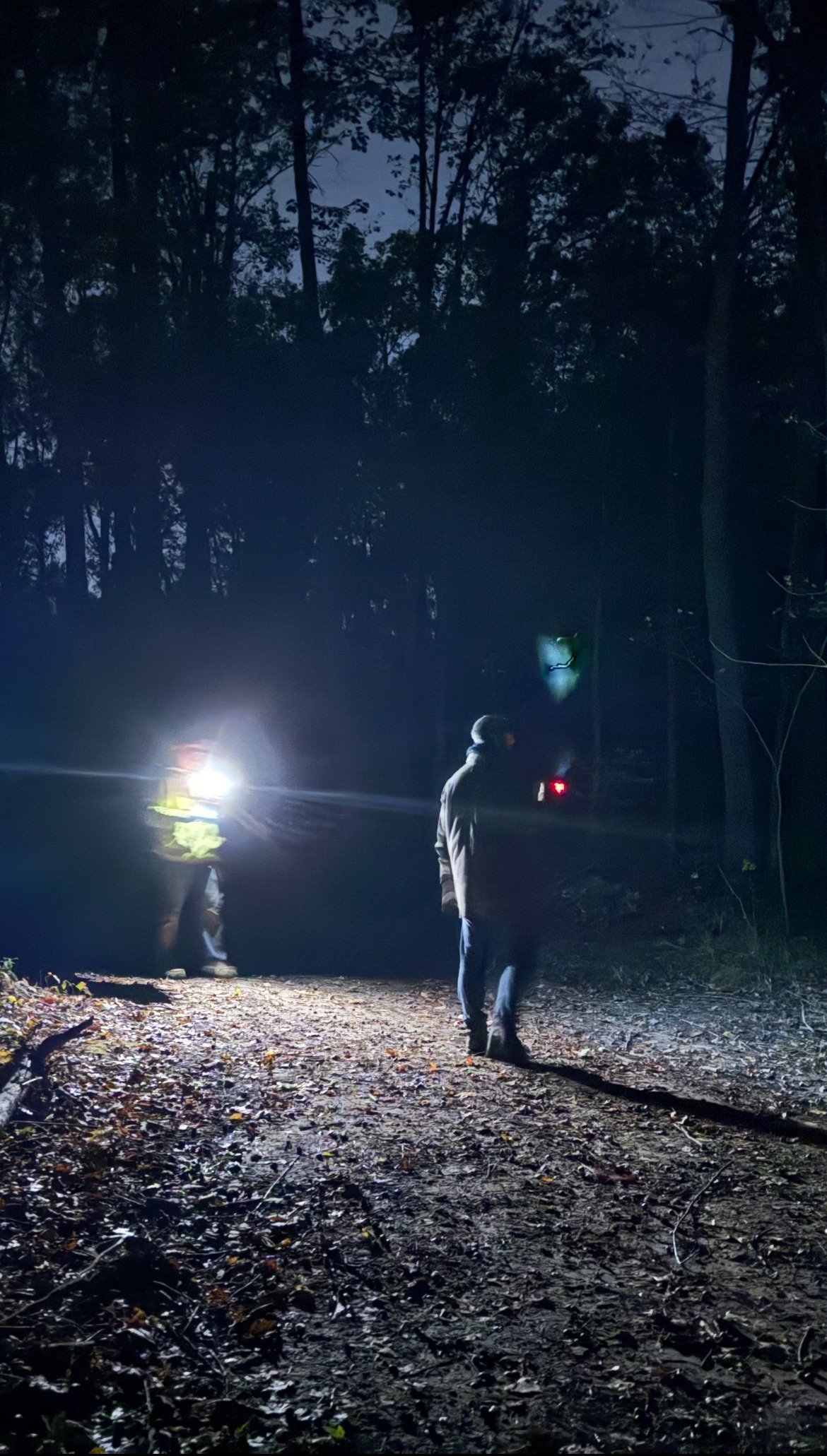 Ghost hunt photograph showing a blue glow above an investigator